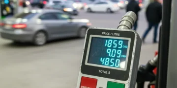 Gas pump showing Canadian fuel prices fluctuating, symbolizing market changes.